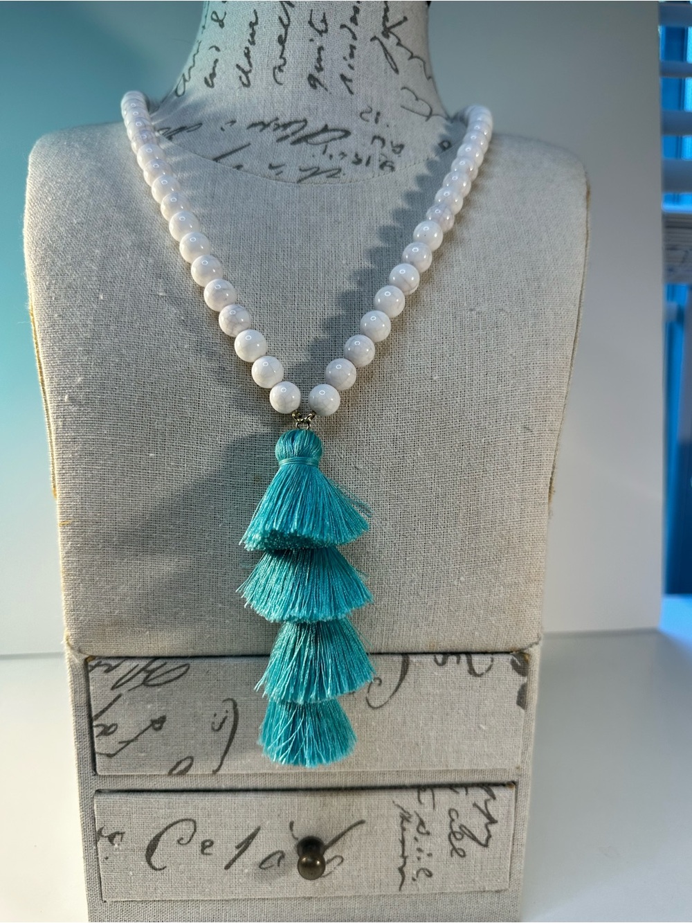 White Beaded Necklace with Teal Tassel Pendant